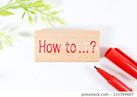Red lettering "How to" and a red pen. Image of learning and questions. Red lettering "How to" and a red pen. Image of learning and questions. 133394667