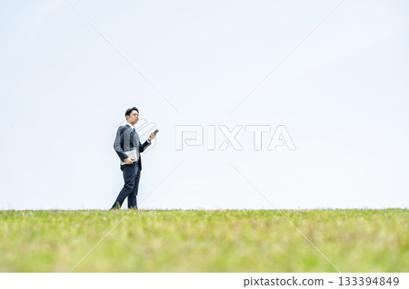 Businessman walking with smartphone in the sky Businessman walking with smartphone in the sky 133394849