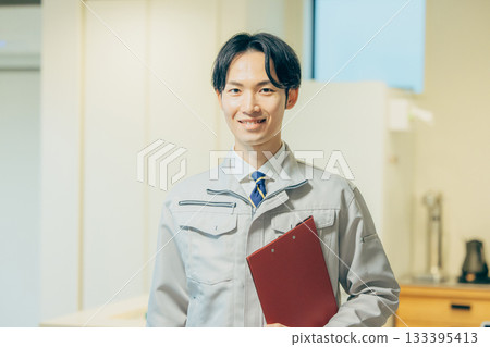 Smiling man in work clothes Smiling man in work clothes 133395413