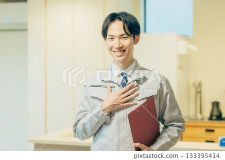 Smiling man in work clothes 133395414