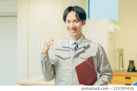 Smiling man in work clothes Smiling man in work clothes 133395416