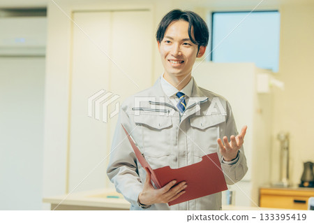 Smiling man in work clothes 133395419