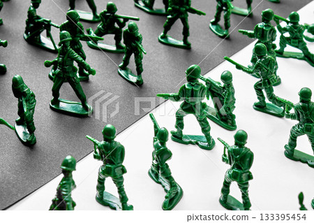 Toy soldiers fighting on a black and white background Toy soldiers fighting on a black and white background 133395454