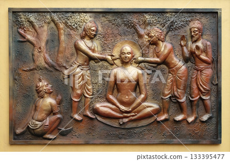 The pegs are being extracted with the help incers, Street bass relief on the wall of Jain Temple (also called Parshwanath Temple) in Kolkata, West Bengal, India 133395477