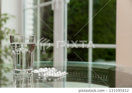 Healthy Morning Routine Pills and Water on Glass Table Healthy Morning Routine Pills and Water on Glass Table 133395812