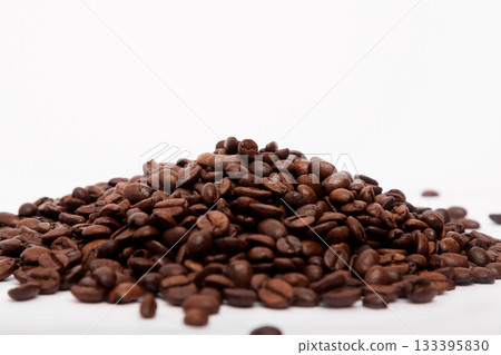 Pile of roasted coffee beans on white background 133395830
