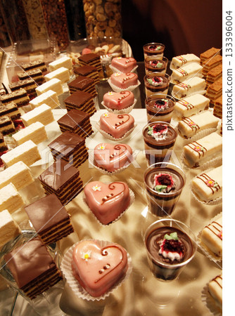 Colorful desserts and pastry served on a wedding party Colorful desserts and pastry served on a wedding party 133396004