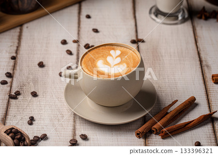 Creamy latte with foam art on rustic table 133396321