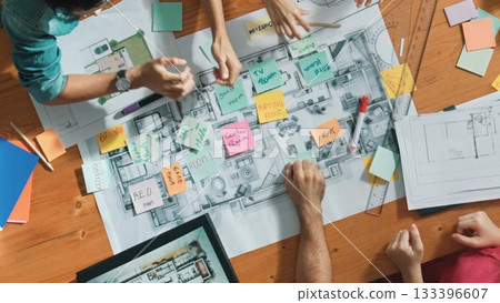 Top down view of designer putting hands together at meeting table. Symposium. Top down view of designer putting hands together at meeting table. Symposium. 133396607