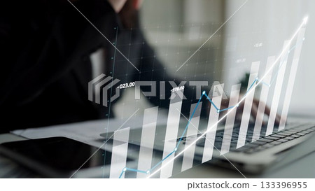 Business professional analyzing financial data with interactive graph overlay on laptop in a modern office setting Copula Business professional analyzing financial data with interactive graph overlay on laptop in a modern office setting Copula 133396955