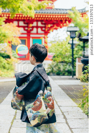 A boy in a kimono visiting a shrine for Shichi-Go-San A boy in a kimono visiting a shrine for Shichi-Go-San 133397013