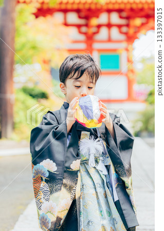 A boy in a kimono visiting a shrine for Shichi-Go-San A boy in a kimono visiting a shrine for Shichi-Go-San 133397015