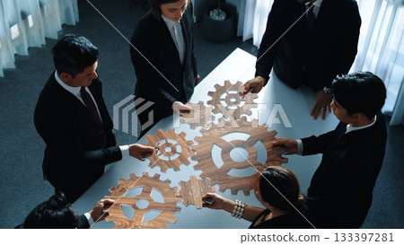 Top view of business team bring filled last cog to complete system. Directorate. 133397281