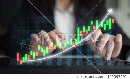 Business Professional Analyzing Financial Market Trends with Data Visualization and Stock Charts on a Laptop Keyboard in an Office Environment Copula 133397391
