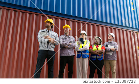 Diverse logistics and engineering team standing confidently in front of shipping containers. Concept of teamwork, global trade, industry, and supply chain management Diverse logistics and engineering team standing confidently in front of shipping containers. Concept of teamwork, global trade, industry, and supply chain management 133397728