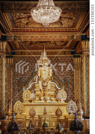 Inside the Golden Temple at Wat Tha Sung, Uthai Thani Province, Thailand, golden Thai patterns and dazzling ornaments fill the room, with a golden Buddha image at its center. Inside the Golden Temple at Wat Tha Sung, Uthai Thani Province, Thailand, golden Thai patterns and dazzling ornaments fill the room, with a golden Buddha image at its center. 133398103