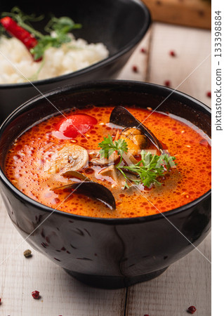 Spicy tom yam soup with rice served together 133398884