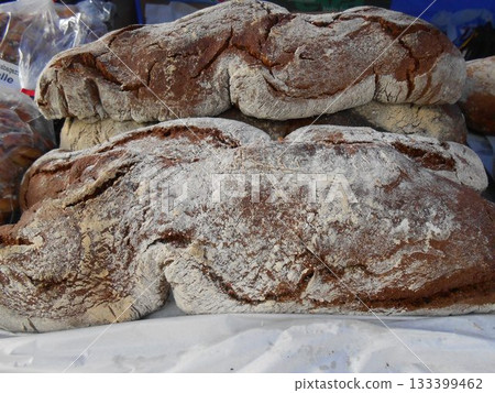Rustic sourdough bread with cut slices on a wooden table 133399462