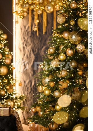 Close-up of a beautifully decorated Christmas tree with golden ornaments, sparkling lights, and festive bokeh in the background. 133399764