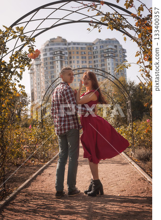 Happy young couple in love spending time together in autumn park hugging 133400357