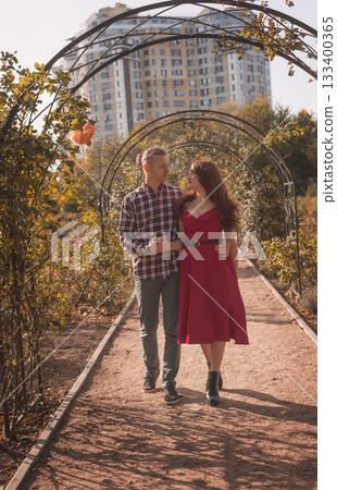 Happy young couple in love in autumn coats spending time together in autumn park hugging 133400365