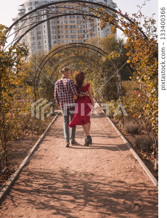Happy young couple in love spending time together in autumn park hugging Happy young couple in love spending time together in autumn park hugging 133400366