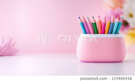 Colorful pencils arranged in a pink holder on a soft pastel background 133400438