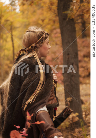 warrior girls with sword in hands in autumn forest. warrior girls with sword in hands in autumn forest. 133400538