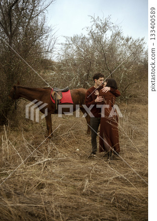 Young romantic couple kissing and horse riding Young romantic couple kissing and horse riding 133400589