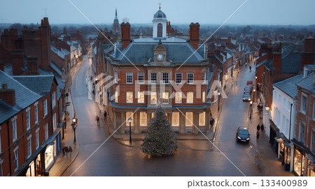 High angle view of a quaint English town square decorated for Christmas at dusk. The festive scene creates a cozy, traditional holiday mood. Perfect for seasonal and travel themes. 133400989