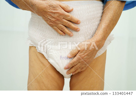 Asian senior woman patient wearing adult incontinence diaper pad in hospital. 133401447