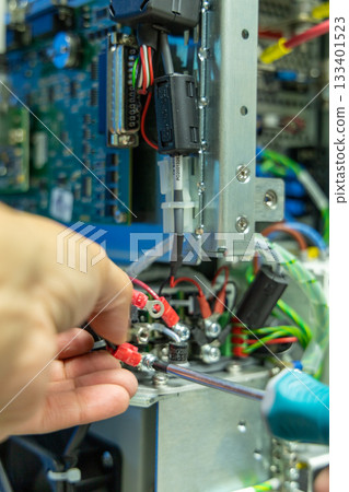 Man's hand repairing an electronic board 133401523