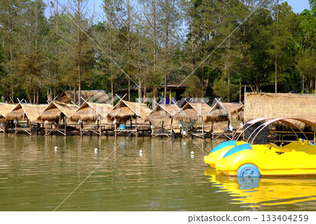 thatched building by the river for customers to dine in a local restaurant in Thailand thatched building by the river for customers to dine in a local restaurant in Thailand 133404259