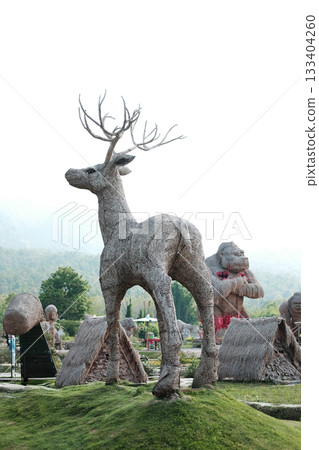 The deer puppet is made from woven straw into the shape of a large deer on green grass at Huay Tung Tao Reservoir The deer puppet is made from woven straw into the shape of a large deer on green grass at Huay Tung Tao Reservoir 133404260