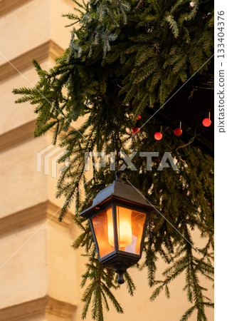 Christmas tree with many ornaments and pine cones. Christmas tree with many ornaments and pine cones. 133404376