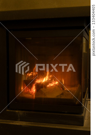 burning wood in the fireplace. the cozy atmosphere of a country house.  133404405