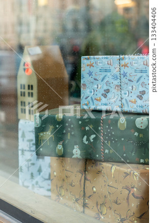 showcase with Christmas gifts and houses. houses are made of cardboard. showcase with Christmas gifts and houses. houses are made of cardboard. 133404406