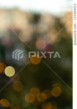 Blurry image of Christmas tree with a lot of yellow and orange lights. Blurry image of Christmas tree with a lot of yellow and orange lights. 133404411