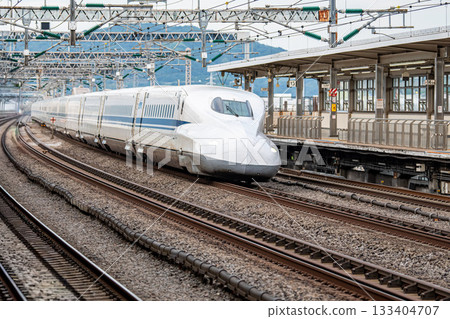 The Tokaido-Sanyo Shinkansen train passes through the platform and leaves The Tokaido-Sanyo Shinkansen train passes through the platform and leaves 133404707