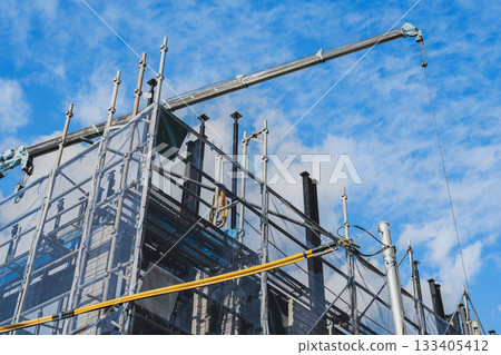 Blue sky, crane and construction site 133405412