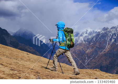 Backpacking woman hiking on high altitude mountain top 133405460