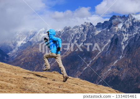 Woman trail runner running in grassland Woman trail runner running in grassland 133405461