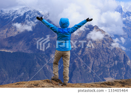 Successful woman hiker on high altitude mountain top Successful woman hiker on high altitude mountain top 133405464
