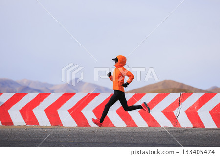 Fitness woman trail runner running on trail leading to Mount Everest in tibet, China Fitness woman trail runner running on trail leading to Mount Everest in tibet, China 133405474