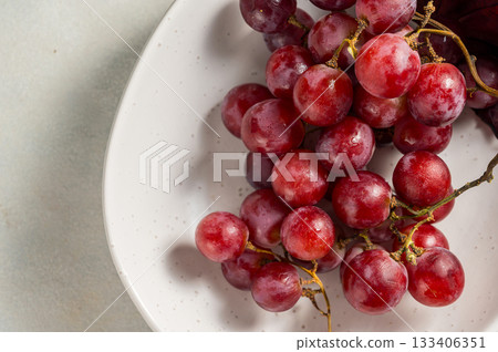 Pink grapes in a white plate, autumn harvest concept, copy space Pink grapes in a white plate, autumn harvest concept, copy space 133406351