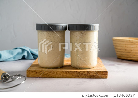 Fresh leaven sourdough starter in glass jars, bright background Fresh leaven sourdough starter in glass jars, bright background 133406357
