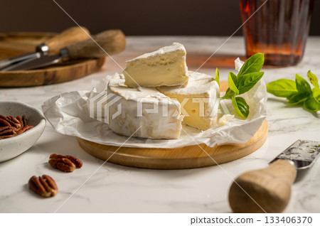 Camembert soft round cheese, served with honey, nuts and dried fruits. Cheese board 133406370