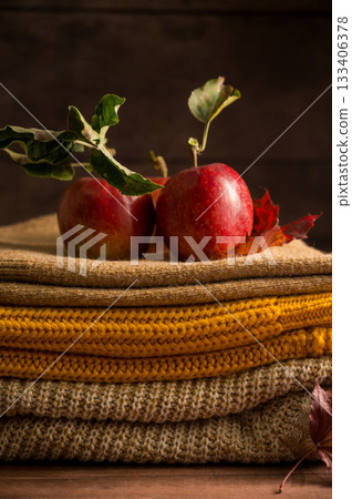 Autumn rustic background. A notebook with apples, leaves and knitted blankets. Dark, moody style 133406378