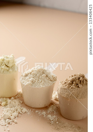 Protein powder in scoops. Different flavours of whey protein powder, copy space. 133406425