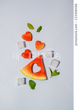 Watermelon triangle slice and heart isolated on blue background Watermelon triangle slice and heart isolated on blue background 133406486